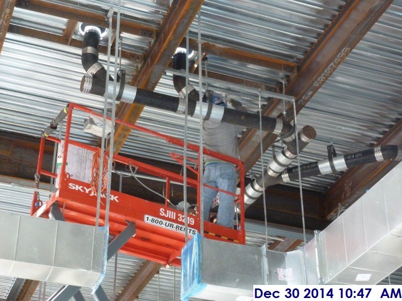 Installing duct work hangers at the 4th floor Facing West